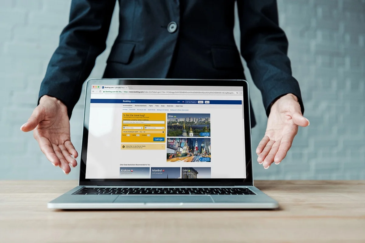 A person pointing to a website on a laptop screen, demonstrating how a digital presence helps a small business attract new customers and improve SEO.