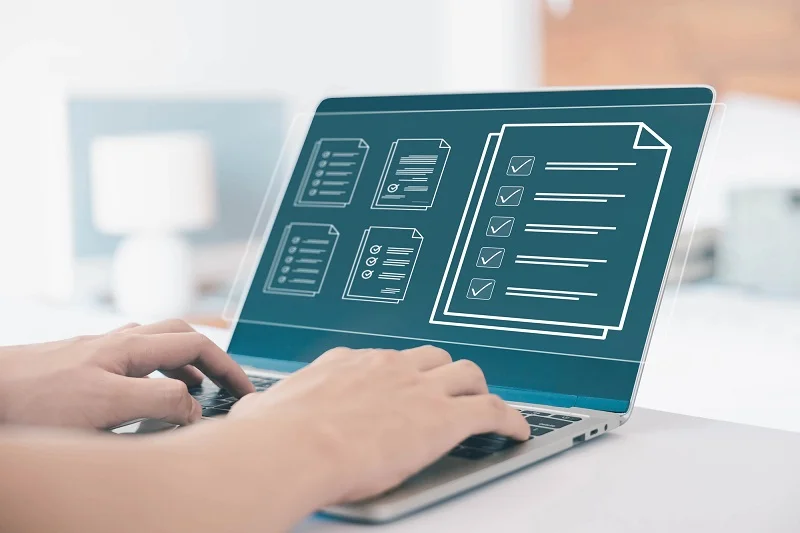 Business owner planning website layout on laptop
